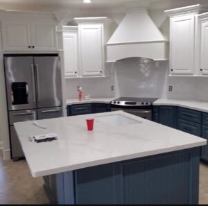 Two-tone kitchen cabinet painting in Wollongong with navy base cabinets and white uppers